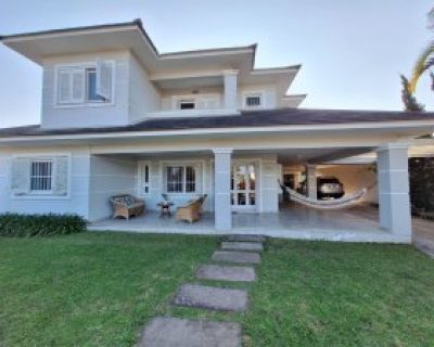 Casa à venda com 395m², 7 dormitórios, 4 suítes, 2 vagas no bairro Atlântida em Xangri-Lá